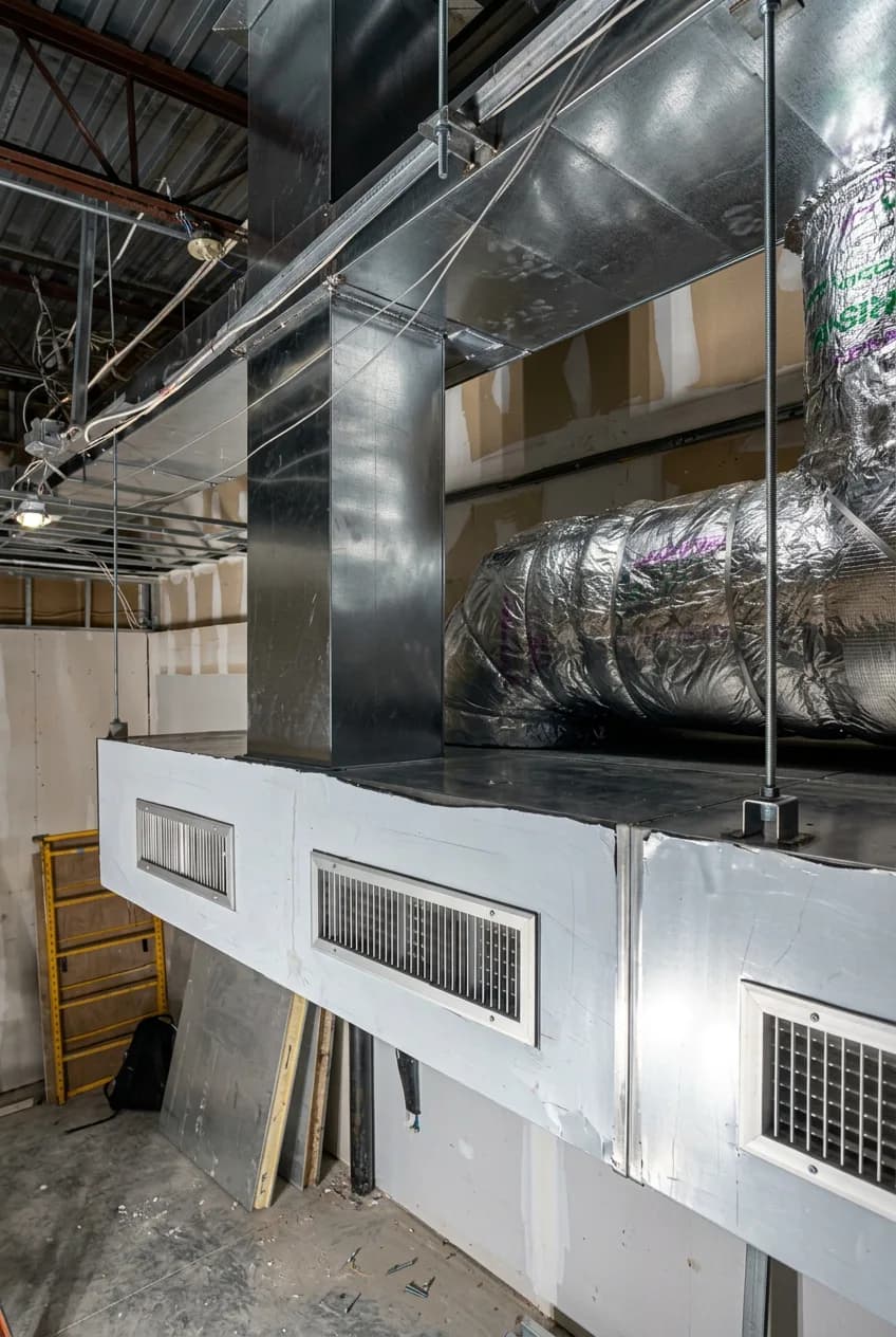 Commercial HVAC ductwork installation with insulated flex duct and vents