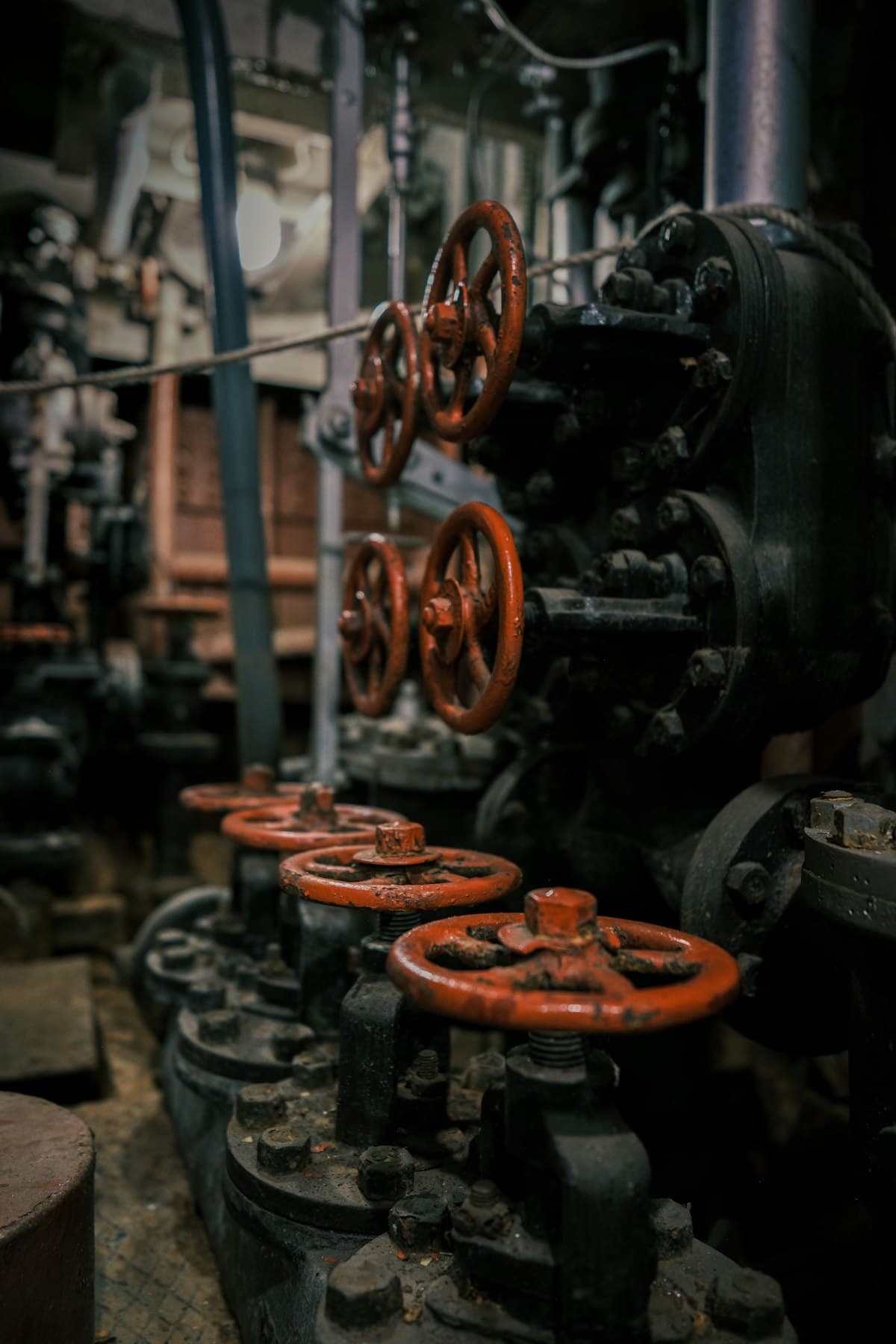 Red industrial valve controls in a building mechanical room